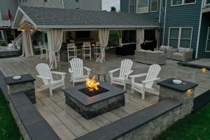 Custom built fire pit and a new modern patio with retaining walls in Brighton, NY